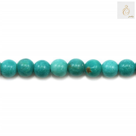 Close-up view of 2mm reconstituted turquoise round beads displaying consistent size and quality for jewelry making