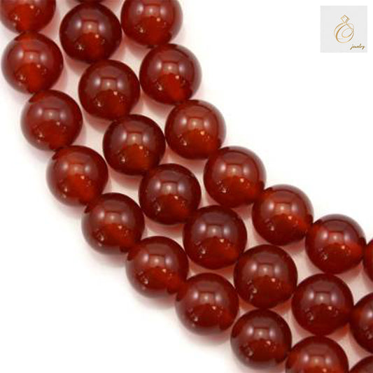Natural red agate round beads 10mm diameter arranged on strand showing rich red color and smooth polished finish