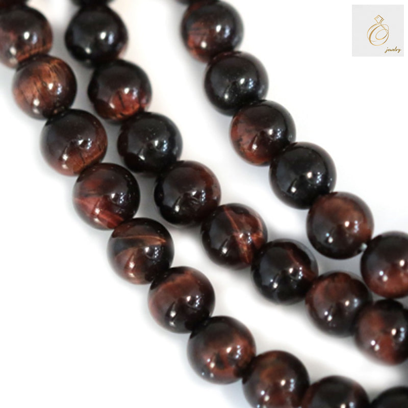 Red tiger's eye round beads strand 4mm diameter showing natural chatoyancy and reddish-brown color patterns