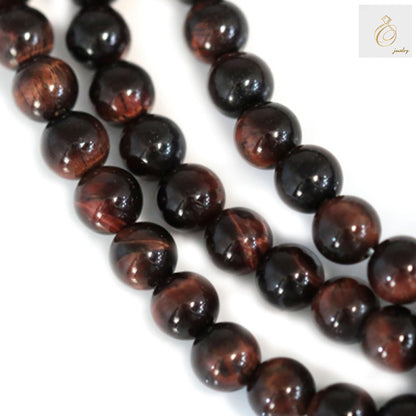 Red tiger's eye round beads strand 4mm diameter showing natural chatoyancy and reddish-brown color patterns