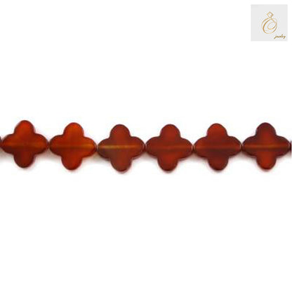 Close-up view of red agate four-leaf clover shaped beads 10mm size