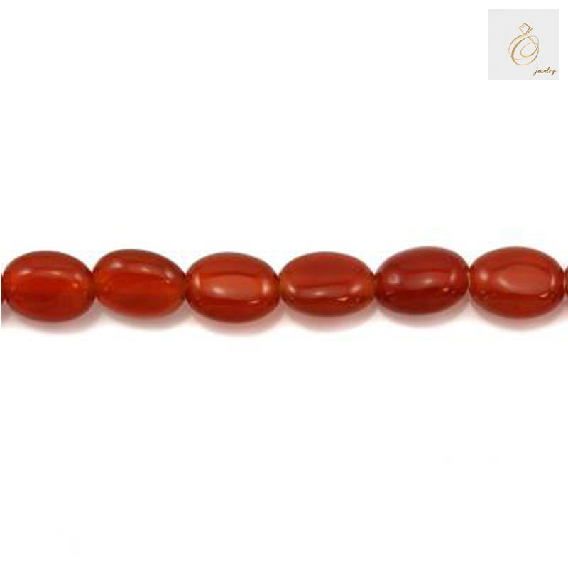 Close-up view of red agate oval beads 6x8mm displaying natural stone patterns and vibrant red coloring