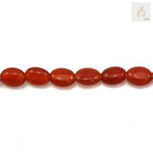 Close-up view of red agate oval beads 6x8mm displaying natural stone patterns and vibrant red coloring
