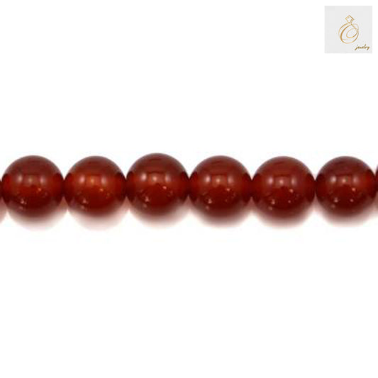 Close-up view of 10mm red agate gemstone beads displaying natural banding patterns and deep red tones