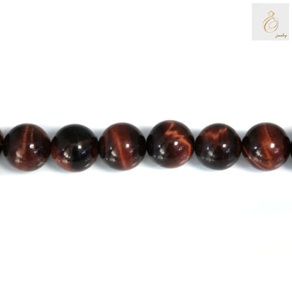 Close-up view of Red Tiger's Eye beads showing natural chatoyancy and reddish-brown color patterns