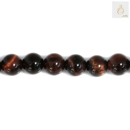 Close-up view of Red Tiger's Eye gemstone beads showing natural patterns and smooth round finish, perfect for DIY jewelry projects