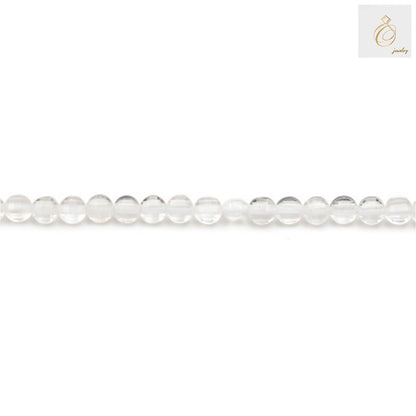 Close-up view of rock crystal faceted flat round beads showing clarity and cut quality