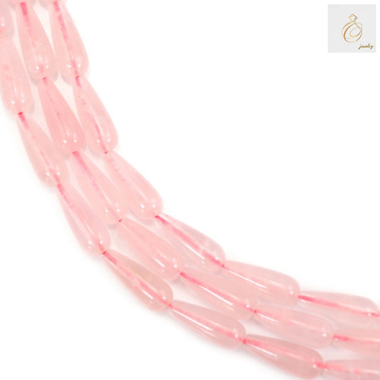 Natural rose quartz drop beads 6x16mm with 1mm holes arranged on strand for jewelry making