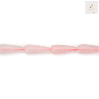 Close-up view of pink rose quartz teardrop shaped gemstone beads showing natural color variations