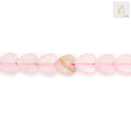 Close-up view of rose quartz heart beads showing natural pink color and heart shape detail 