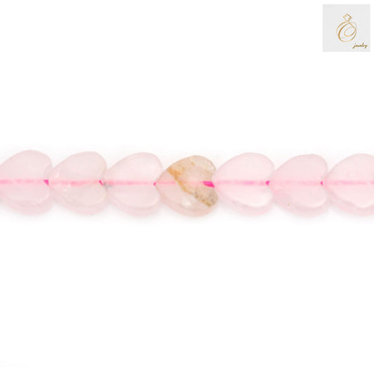 Close-up view of rose quartz heart beads showing natural pink color and heart shape detail 