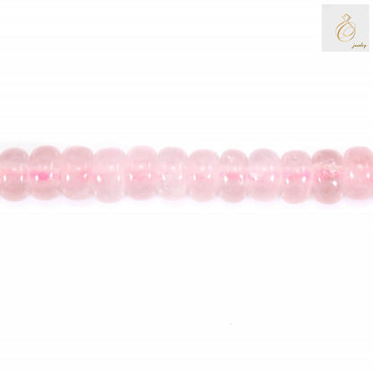 Close-up view of rose quartz heishi disc beads showing natural pink color and smooth finish