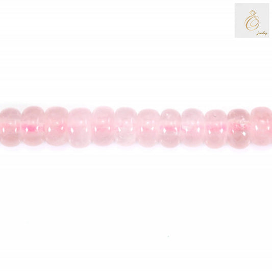 Close-up view of rose quartz heishi disc beads showing natural pink color and smooth finish