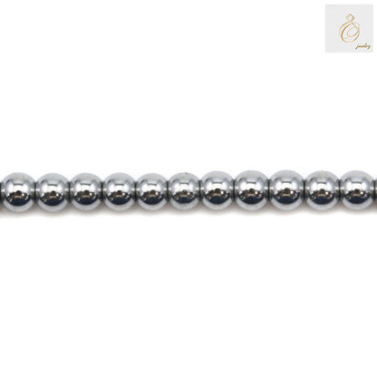Silver hematite round beads 2mm diameter with metallic finish on white background