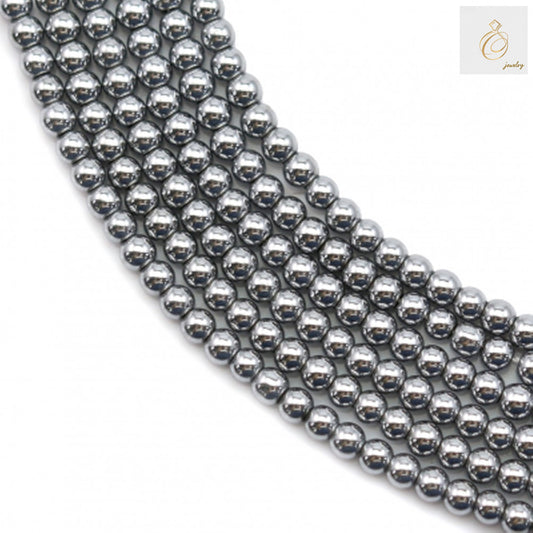 Close-up view of silver hematite beads 2mm showing uniform round shape and lustrous surface