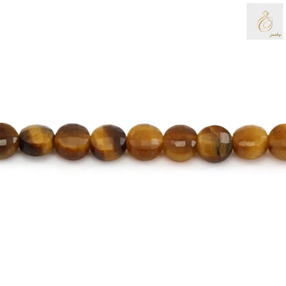 Close-up view of 4mm tiger's eye faceted round gemstone beads displaying natural golden luster and smooth finish