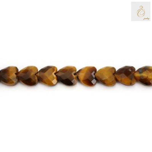 Close-up view of Tiger's Eye heart-shaped gemstone beads displaying natural golden striations and polished surface