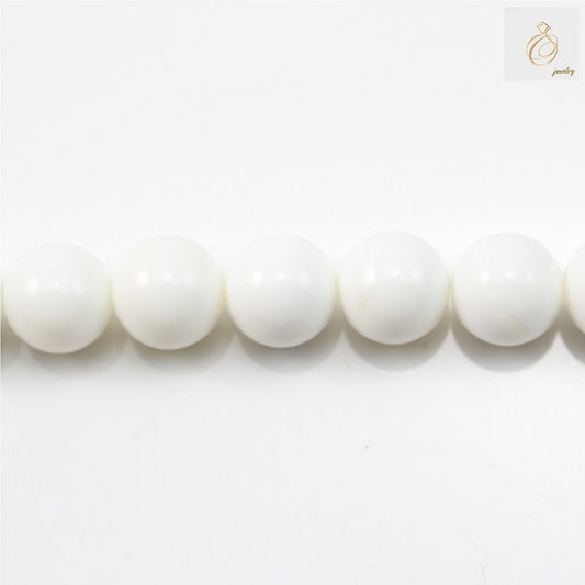 Natural tridacnidae round beads 16mm diameter on white background"