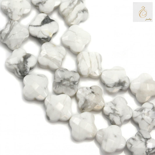 White howlite faceted flower beads 10mm diameter on strand"
"Faceted white howlite flower-shaped beads for jewelry making