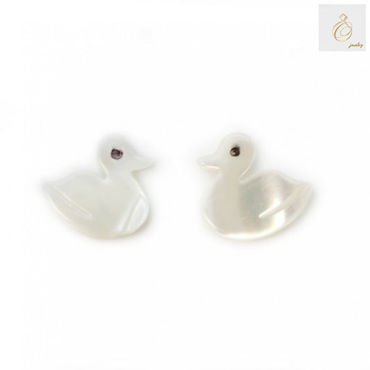 Close-up view of white mother-of-pearl duck beads displaying natural shell texture and lustrous finish