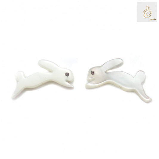 Close-up view of white mother of pearl shell rabbit beads, 8x15mm, displaying natural iridescent finish and precise rabbit carving details