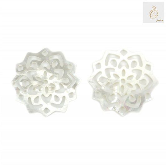 Close-up view of white mother-of-pearl shell floral charm showing natural iridescent finish and detailed craftsmanship