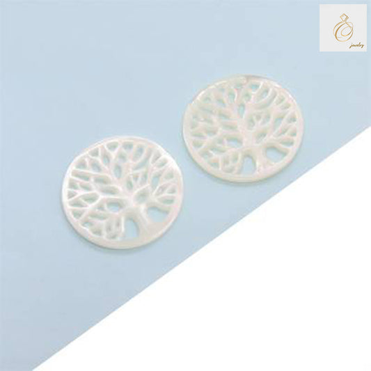 Close-up view of white mother-of-pearl Tree of Life charm showing detailed carving and natural shell texture, 24mm size