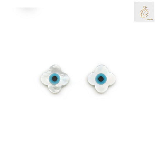 Close-up view of white mother-of-pearl evil eye clover charms showing lustrous finish and detailed craftsmanship