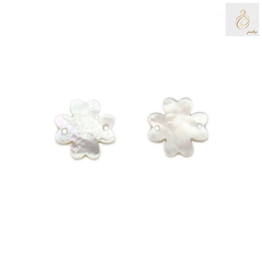Close-up view of white mother-of-pearl clover charms showing natural iridescent surface texture