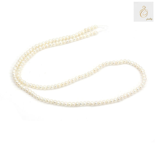 Close-up of white round cultured pearls showing natural luster and qualityWhite freshwater pearl strand on display showing size and color consistency