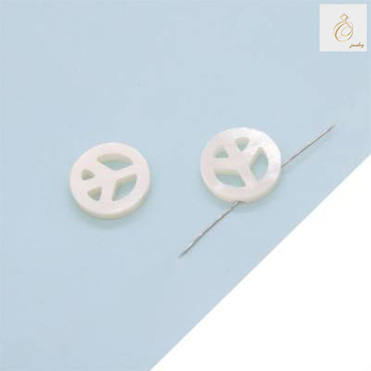 Close-up view of white mother-of-pearl peace and love heart charm showing detailed craftsmanship and natural shell texture