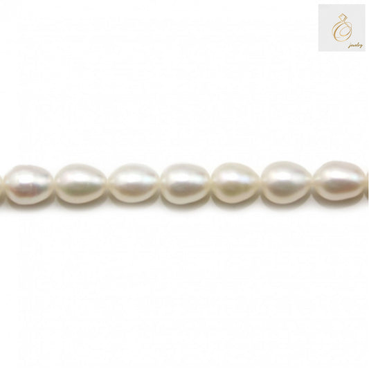 White freshwater cultured pearl strand with oval 6-7mm pearls, 39-40cm length"
"Premium white oval freshwater pearls arranged in strand for jewelry making"
"Close-up of lustrous white cultured pearls showing natural nacre and smooth surface