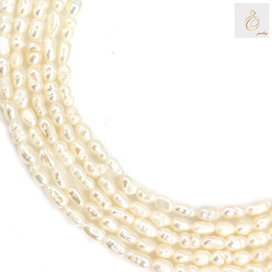 White freshwater cultured pearl strand with oval 3-4mm pearls, 39-40cm length"
"Premium white oval freshwater pearls arranged in strand for jewelry making"
"Lustrous white cultured pearls showing natural oval shape and consistent quality