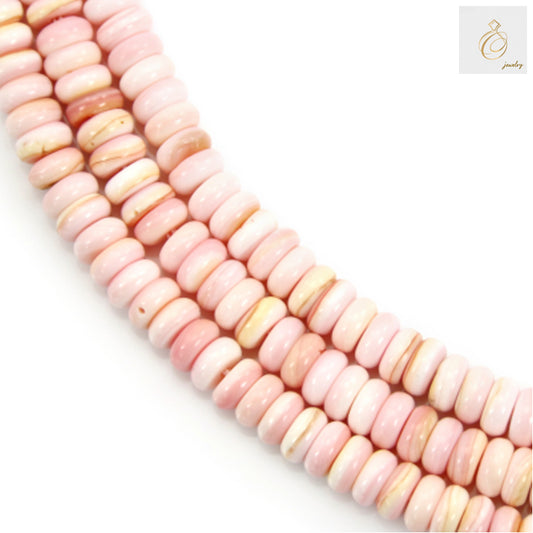 Close-up view of pink shell heishi beads showing uniform 2x5mm size and natural shell texture